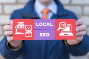 a person holding a sign that says "Local SEO"