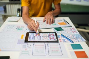 UX developer and ui designer brainstorming about mobile app interface wireframe design with customer brief and color code, User experience concept.